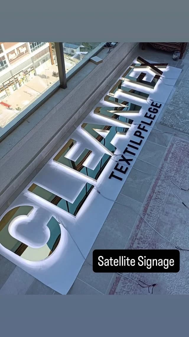 Illuminated 3D business name signage with halo-lit channel letters